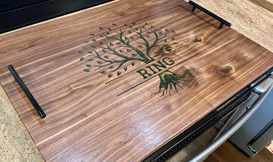 Wooden surface with engraved design and 'RING' text on a kitchen counter.